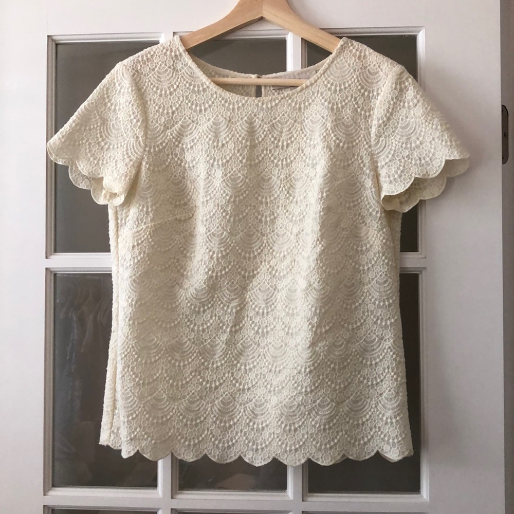 Cream blouse with scalloped hem